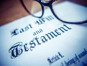 An image of glasses resting on a will, which is often a central document to the final distribution of estate assets.