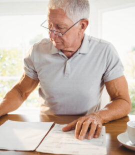 A senior who is calculating his tax deductions after reviewing the key advantages to capitalize on for elderly individuals filing their tax returns.
