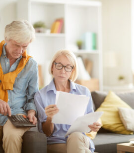 A couple avoiding common tax mistakes after learning all the changing requirements of tax filing for seniors.