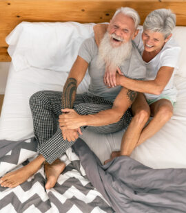 A senior couple smiling and enjoying retirement after their children set up trusts for elderly parents.