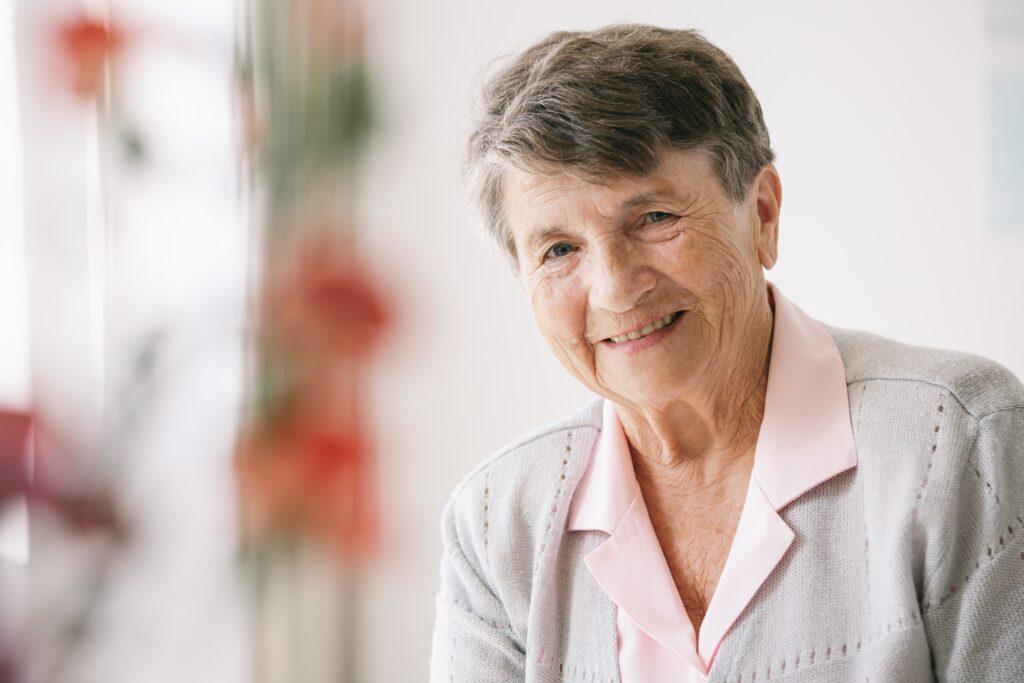 A happy senior after their kids got them the help of a professional fiduciary for the elderly.