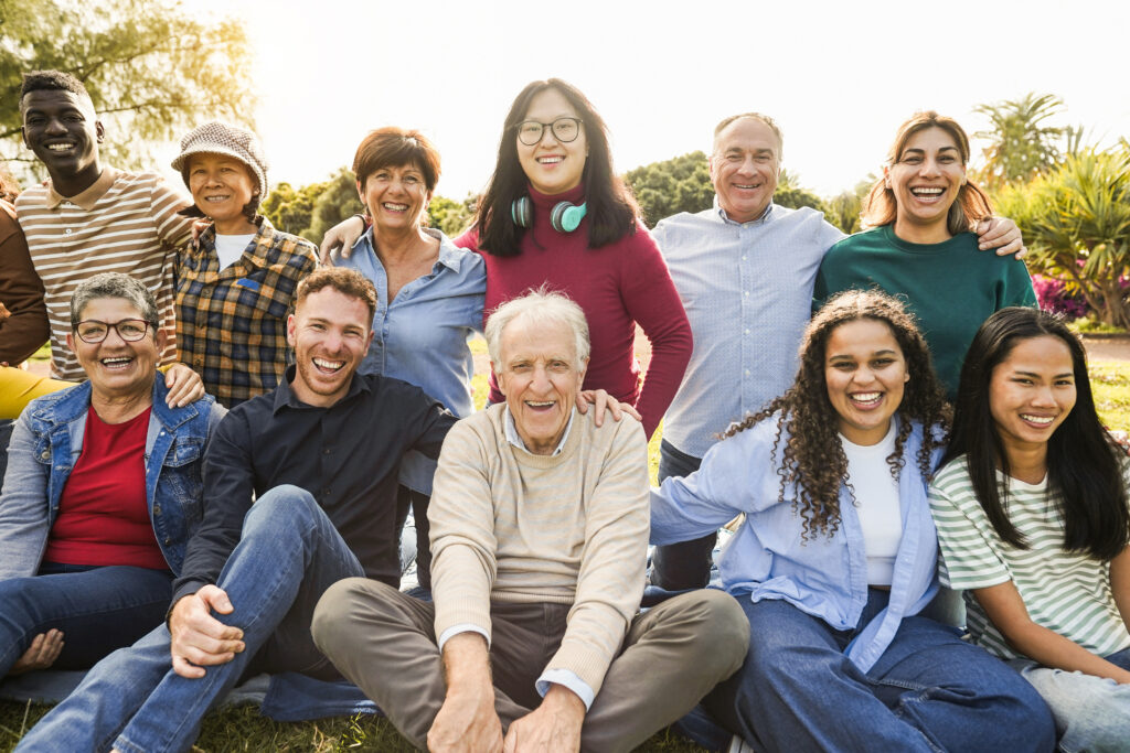 A happy senior with his whole family, smiling because he thoroughly prepared with wealth transfer strategies by utilizing a trust and professional fiduciary.
